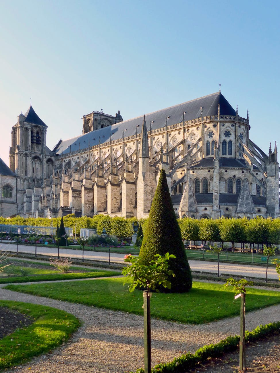 Architecture gothique imposante de la cathédrale Saint-Étienne de Bourges entourée de jardins