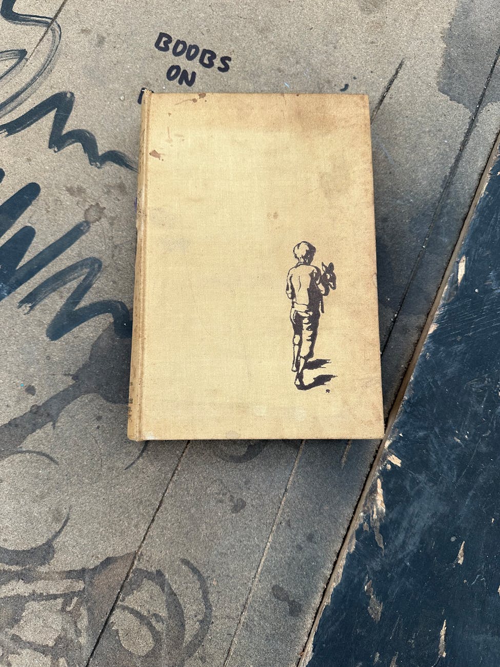 Livre ancien à couverture poussiéreuse avec illustration d'enfant