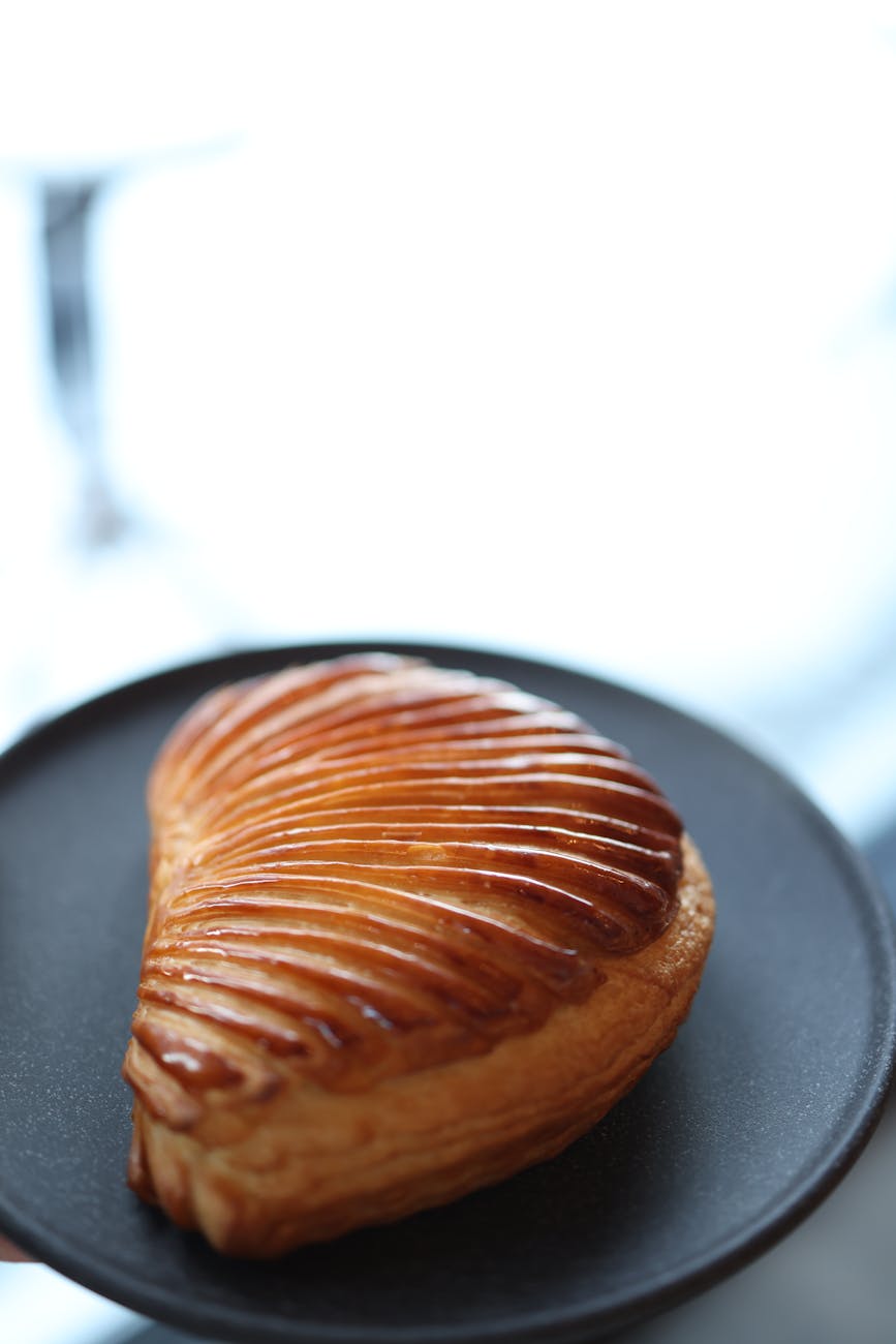 Pâte feuilletée glacée dorée sur assiette noire