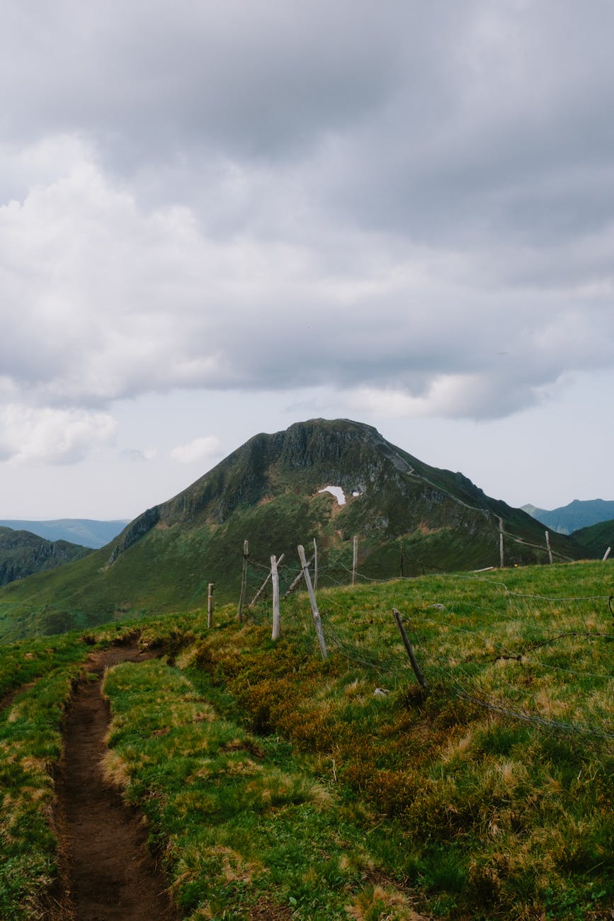 Montagne verdoyante sous un ciel dramatique et nuageux
