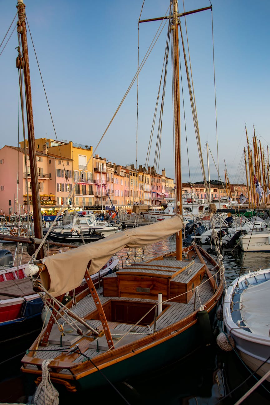 Voiliers en bois amarrés dans le port de Saint-Tropez au coucher du soleil